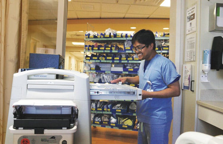 Victor Thach refilling bedside cart at UMMC West in NICU
