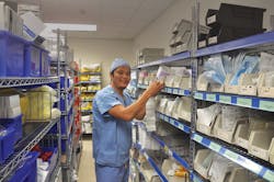 Tenzin Ngawang updating Kanban labels in Fairview Southdale ED storeroom