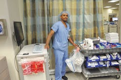 Yonathan Belachew restocking bedside cart in Fairview Southdale ED Yonathan Belachew restocking bedside cart in Fairview Southdale ED