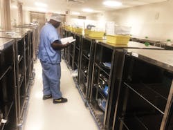 Dave Moore preparing case carts for next day&rsquo;‑s cases