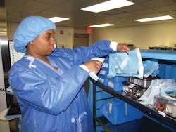 Kristen Collins scans items to a transport cart Kristen Collins scans items to a transport cart