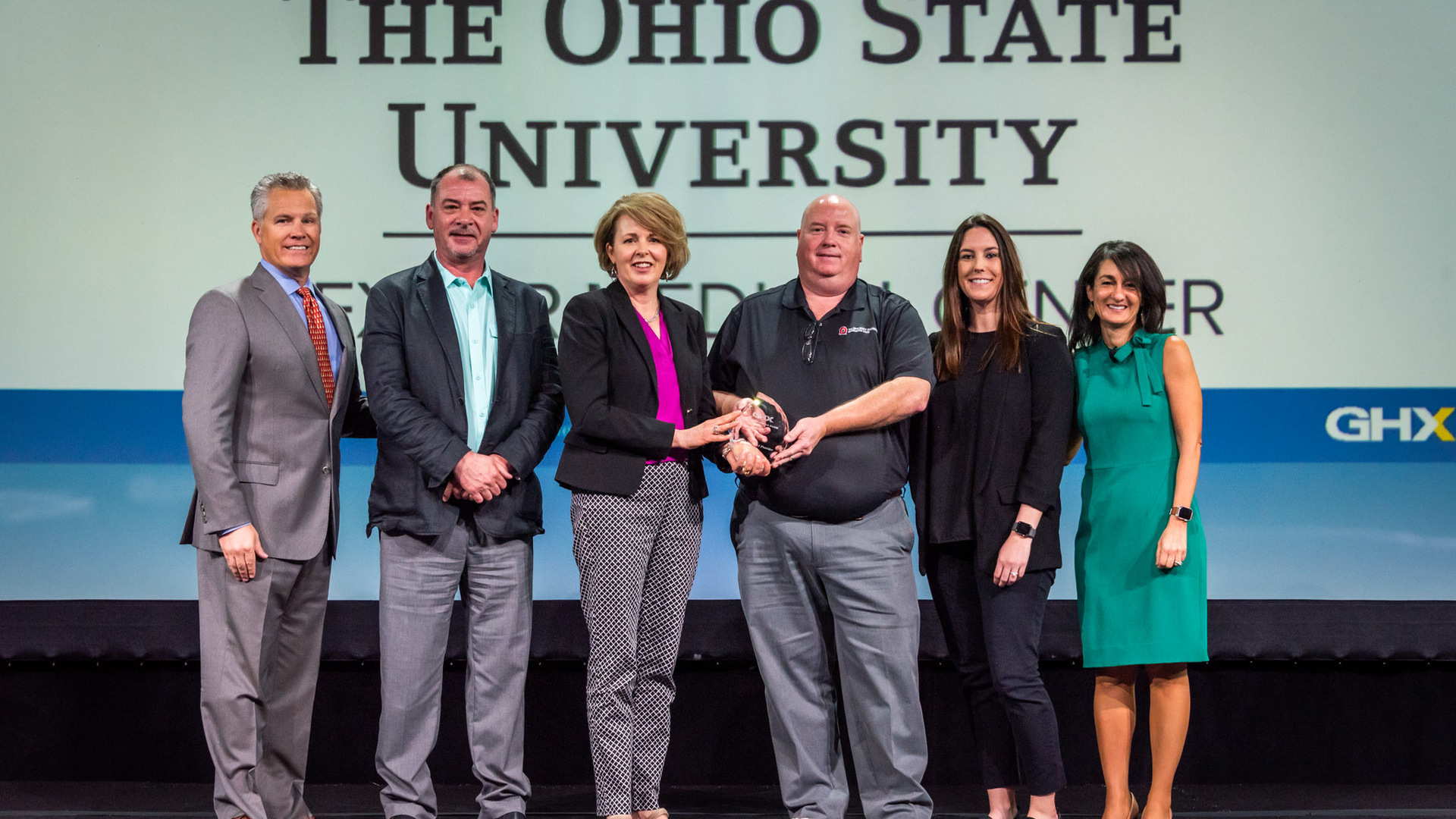The Ohio State University received the GHXcellence award for Most Improved Provider; with GHX's Bruce Johnson, CEO, Brian Picklesimer, Julie Amling, Joel Kroliski, Kelsey Perchak, Tina Vatanka Murphy, Chief Revenue Officer, GHX.