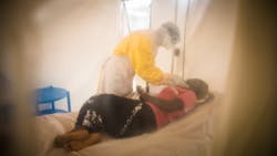 Health Workers treat Julie (15) who is suspected of being infected by Ebola, at the Ebola Treatment Center. Photo: World Bank / Vincent Tremeau Health Workers treat Julie (15) who is suspected of being infected by Ebola, at the Ebola Treatment Center. Photo: World Bank / Vincent Tremeau