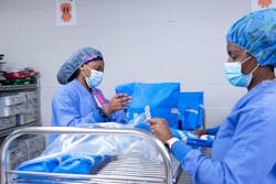 Tech II Shellie Pearsall (left) and Tech II Michele Ginn (right) load sterile instrumentation in sterility maintenance covers. Tech II Shellie Pearsall (left) and Tech II Michele Ginn (right) load sterile instrumentation in sterility maintenance covers.
