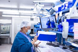 Tech II Daniel Robb restocks a work station. Tech II Daniel Robb restocks a work station.