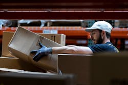 Jacob Taylor picks an order from the shelves. Jacob Taylor picks an order from the shelves.