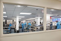 Looking through the window to see what everyone is doing in Decontam, a large, well-lit area equipped with ergonomic Pure Processing sinks and computers. Looking through the window to see what everyone is doing in Decontam, a large, well-lit area equipped with ergonomic Pure Processing sinks and computers.