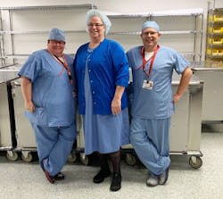 Angela Salmen System Educator (CRCST,CIS,CHL), Jackie Johnson Manager (CST, CRCST, CIS, CHL), and Justin Fordeck System Director(CRCST,CIS,CHL) standing in clean cart holding area Angela Salmen System Educator (CRCST,CIS,CHL), Jackie Johnson Manager (CST, CRCST, CIS, CHL), and Justin Fordeck System Director(CRCST,CIS,CHL) standing in clean cart holding area