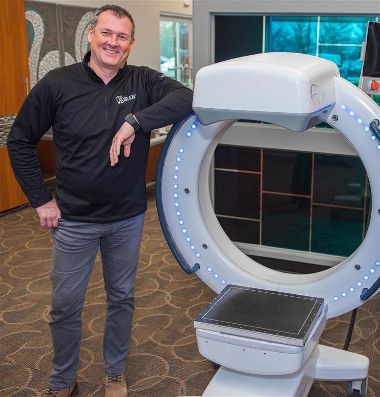 Xoran CEO Misha Rakic with the TRON mobile, full-body fluoroscopy, CT X-ray system