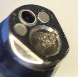 Distal tip of flexible endoscope with visible damage to biopsy channel Distal tip of flexible endoscope with visible damage to biopsy channel