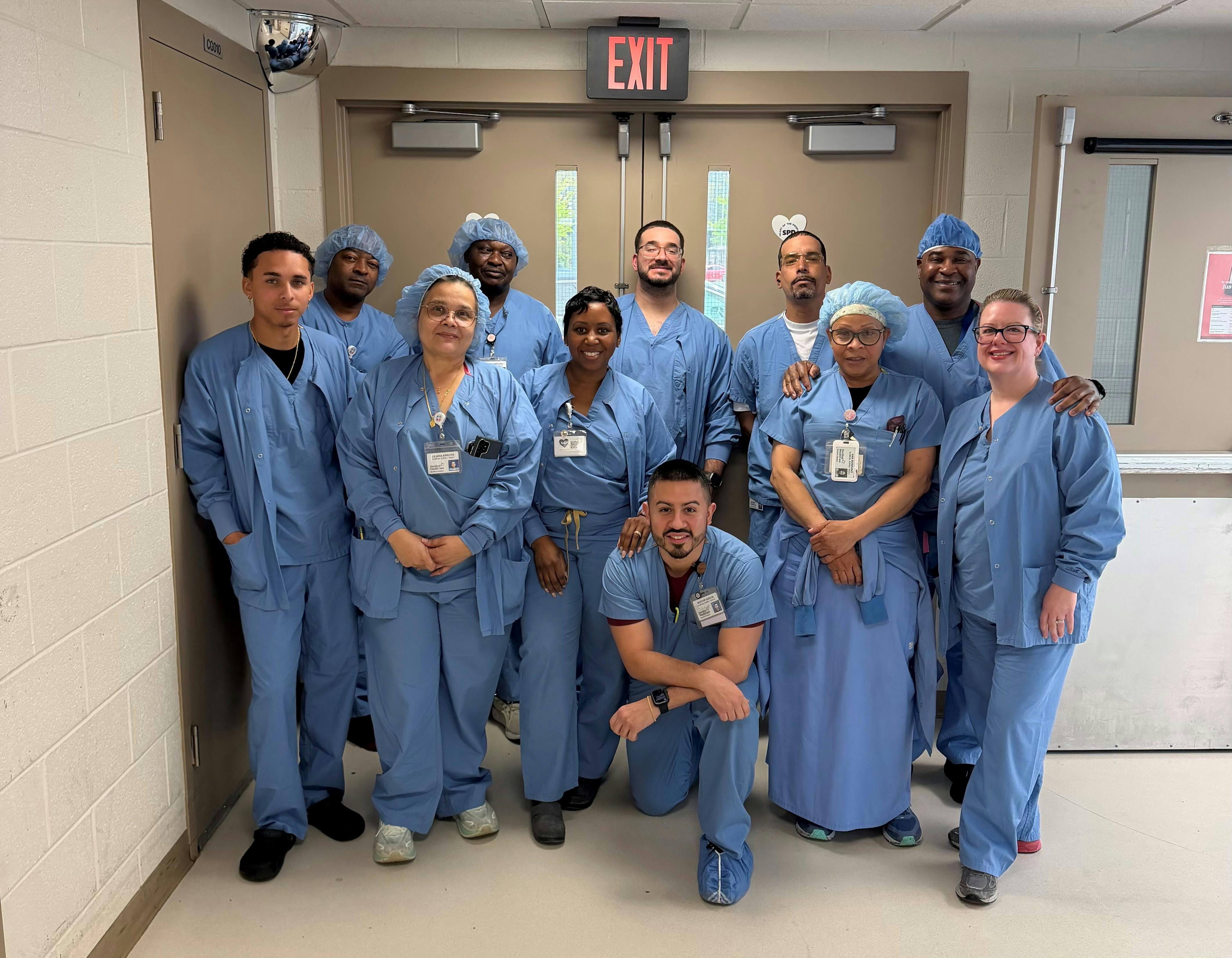Hartford Healthcare Clinical Supply Chain - OR (L_R) Back Row: Richard Harrison, OR Aide | Joseph Chegugu, OR Supply Assoc | Nicholas Bonilla, OR Aide | Francisco Ortiz, Dept Consultant, OR Materials Mgmt. | Byron Allen, CWR Agency Dept Consultant Front Row: Jeremiah Ortiz, Clinical Supply Tech | Liliana Arroyo, Clinical Supply Tech I | Shanique Rochester, OR Materials Coordinator | Ana Serrano, Materials Associate | Kristin Girling, Unit Leader OR Materials Kneeling: Nestor Garcia, Materials Coordinator